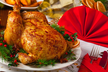 Roasted whole chicken with Christmas decoration.