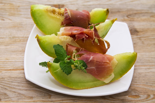 plate of melon with ham