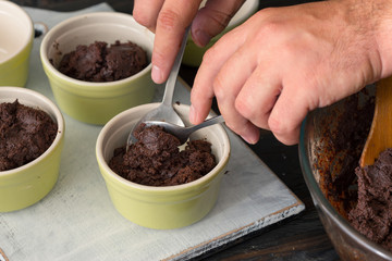 Man prepares a chocolate dessert in the kitchen
