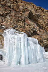 Fototapeta na wymiar Rocks covered by ice on winter siberian Baikail lake