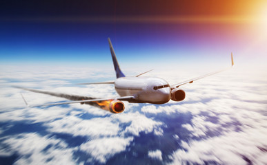 Plane flying in sky with engine on fire