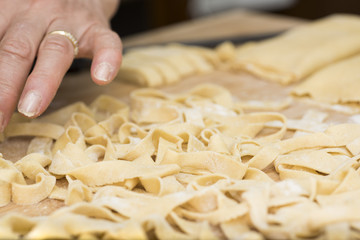 Woman who kneads the homemade pasta to prepare lasagna and tagliatelle.