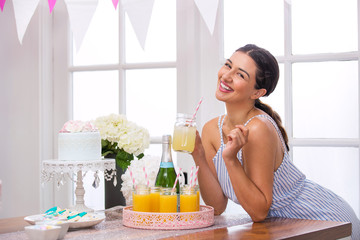 Cute adorable fun woman  party planner organizer homemade mimosa champagne brunch party 
