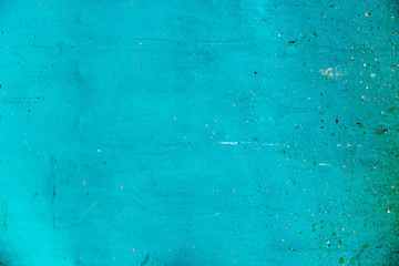 Green turquoise wall background with rough texture and dirt