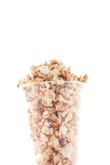 Popcorn in plastic cup on white background.