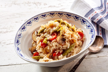 Bowl of risotti with asparagus and tomatoes
