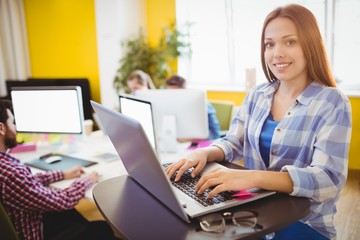 Fototapeta na wymiar Happy businesswoman working with laptop