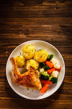 Roast chicken legs with boiled potatoes and vegetables