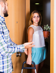 Frustrated couple standing at doorway