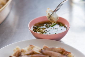 crab on a fork with dipping sauce