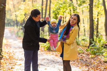 Happy family walking in the park in autumn together