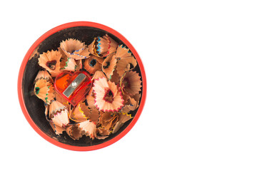 sharpener and shavings in a cup