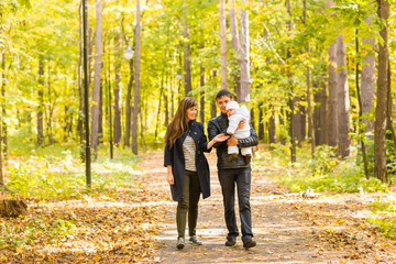 Fototapeta premium friendly family walking in the park in autumn together