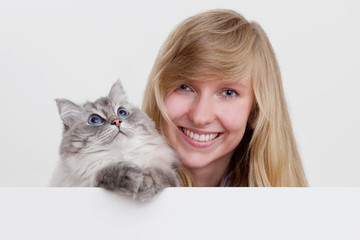 young woman with ragdoll cat and white copyspace