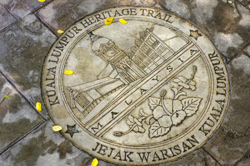 KUALA LUMPUR, MALAYSIA - JANUARY 16, 2016: round memorial pate on ground - symbol of the city.