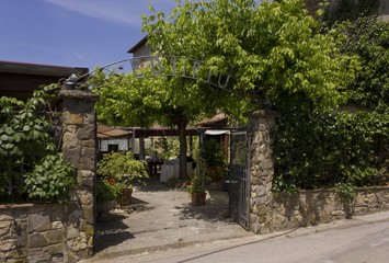 Fototapeta na wymiar External view of the entrance of historical traditional restaurant on Tuscan Hills