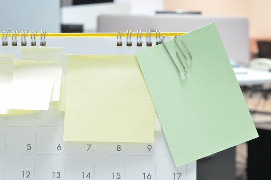 Colorful of paper notes on calendar at business office with copy space for text.