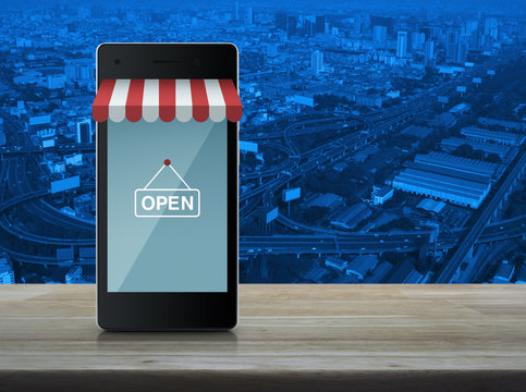 Modern smart mobile phone with on line shopping store graphic an