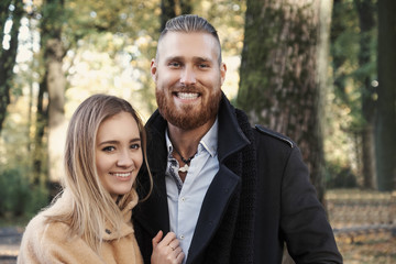  Redhead bearded male hugging cute blonde female.