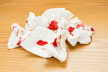 Fototapeta na wymiar bloody tissue on a wood table