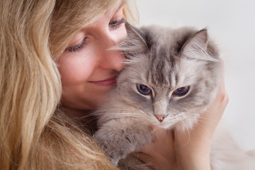 young woman with ragdoll cat