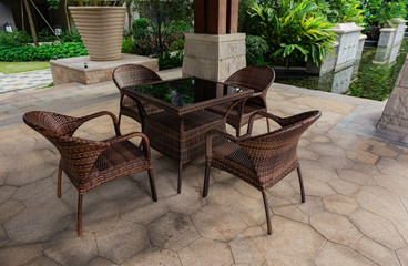 rattan sofa and table set in a garden