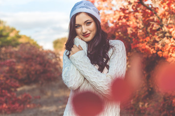 Pretty girl is wearing knitted white winter clothes