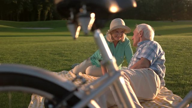 Couple on meadow. Senior man and woman laughing. Best days of our life. When love stops time.