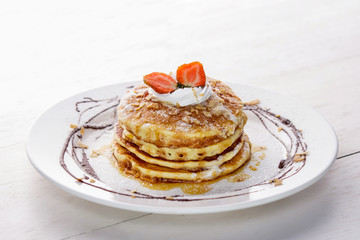 homemade pancake with honey and strawberry topping