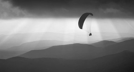 Flying above the foggy hills. Monochrome colors