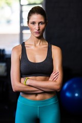 Fototapeta na wymiar Confident young female athlete in gym