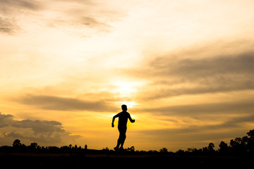 silhouette man jogging on the sunset background