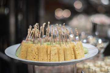 delicious Fruit : Pineapple Slice on plate with a stick prepare for starter in restaurant in Asia. dessert skewers