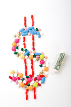 Pills and tablets on white background with dollar symbol in vivid