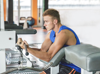 sporty young man exercising his biceps