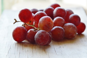 red grape on wooden board