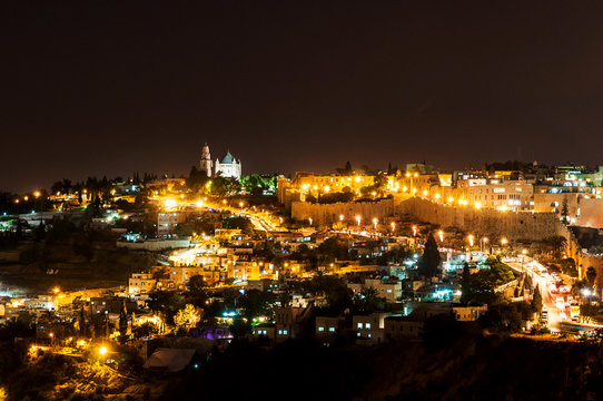 panoramic view of historic town wall and center of jerusalem by night