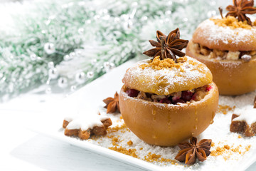 festive baked stuffed apples and gingerbread on white plate 