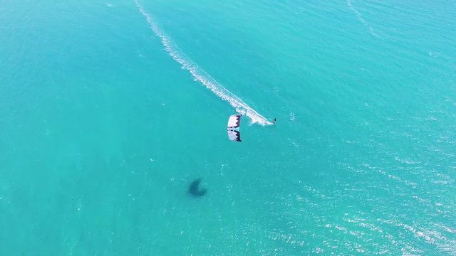 Aerial view of kitesurfing extreme sport with the wind freestyle. Beautiful top view of nice beach.