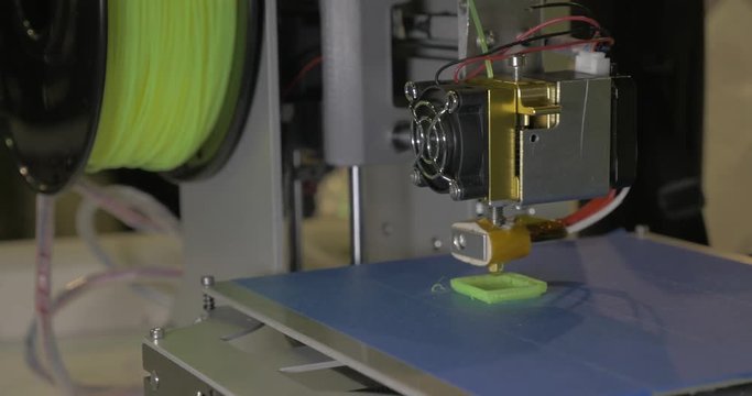 3d printer in process. It makes pieces for equipment with green plastic. In ECC Sokolniki, Moscow at exhibition of 3D Expo
