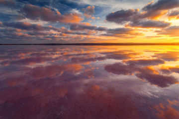 Sky with clouds above salt lake. Beautiful sunset landscape.