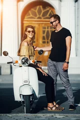 Foto op Plexiglas Cute couple with their scooter © teksomolika