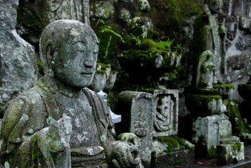 Fototapeta na wymiar Buddhist stone statue in Japanese cemetery