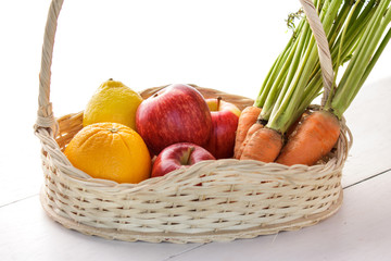 fresh lemons, apples, and carrots in basket