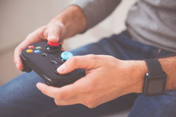 Delighted man playing video games