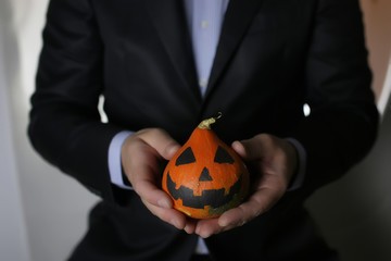 man in suit with pumpkin