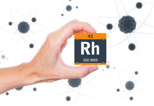 Rhodium element symbol handheld and atoms floating in background - Powered by Adobe