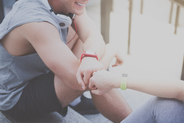 Young sporty couple relaxing together after urban workout.