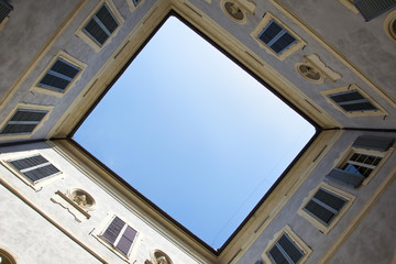  Bottom-up view from courtyard of historic building in Siena, Italy.