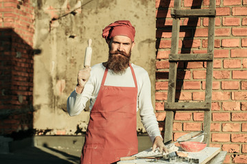 Man cook holding rolling pin